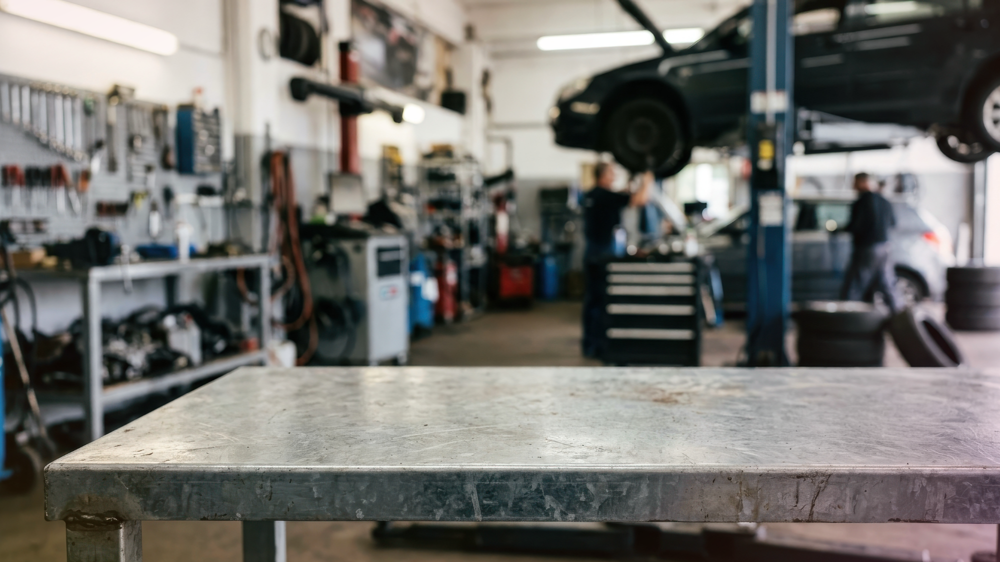 A customer thoughtfully discusses vehicle repair options with a mechanic in a clean auto shop.