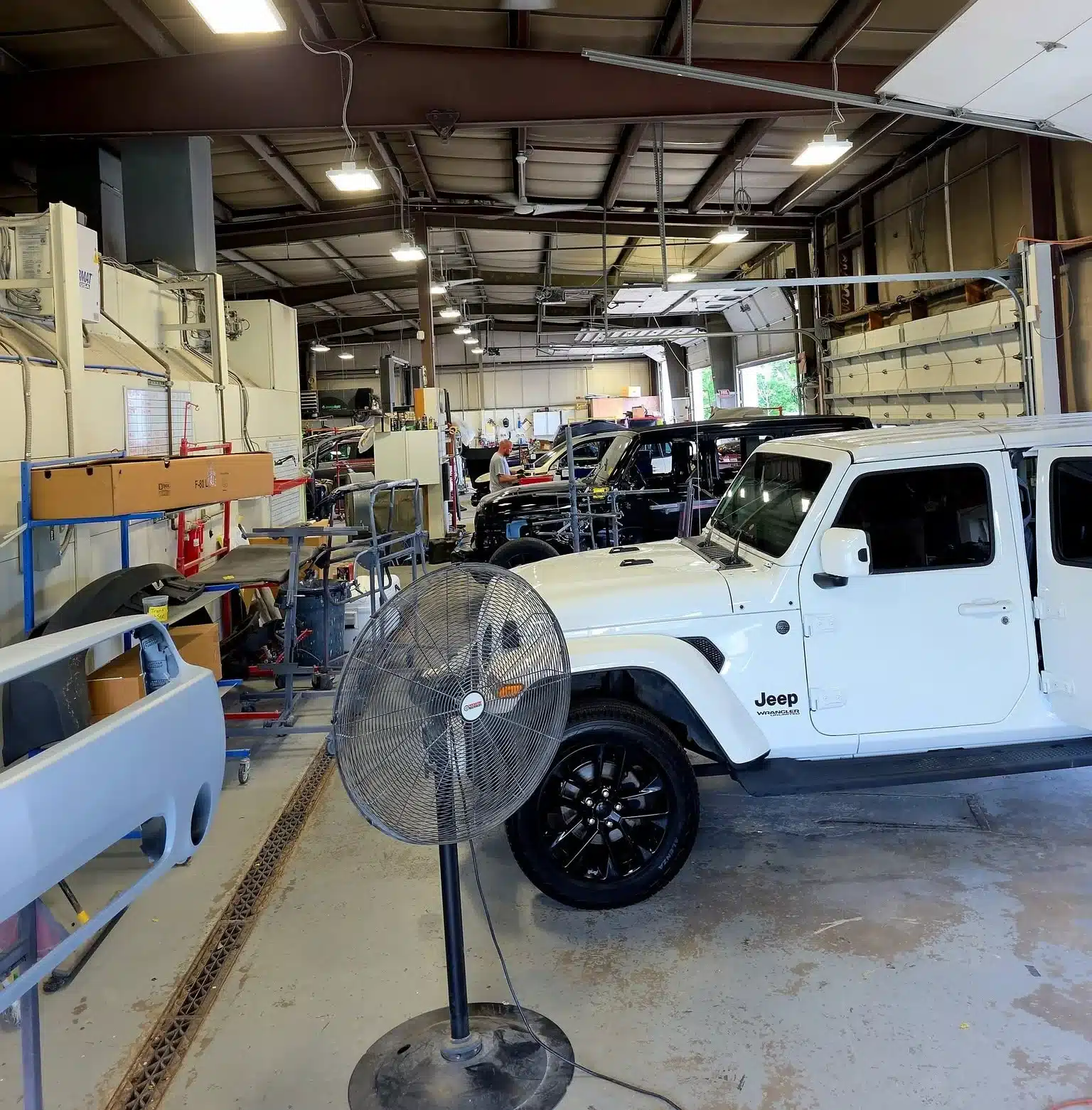 Capitol Collision technician refinishing a vehicle panel