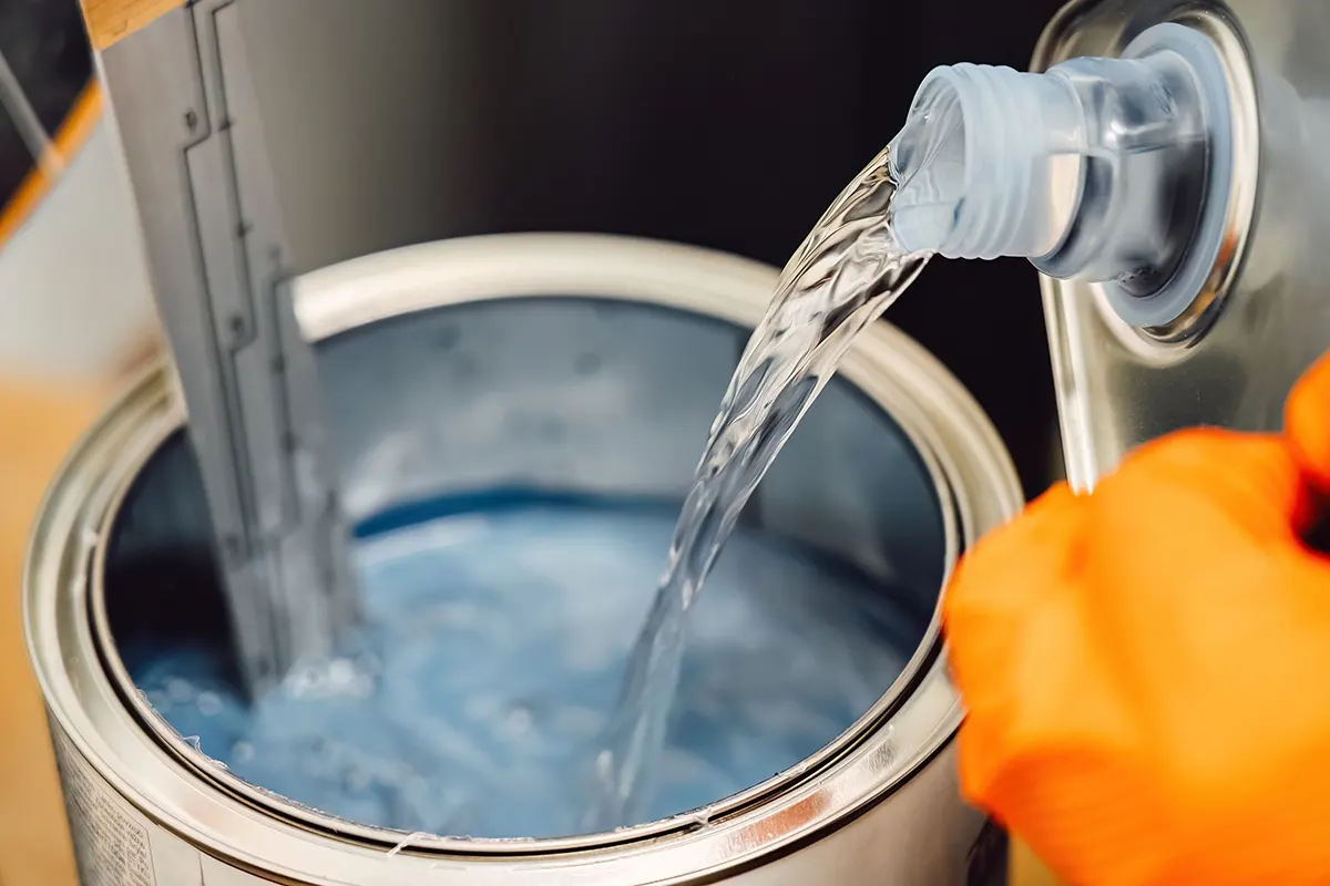 Painter applying color in a downdraft paint booth