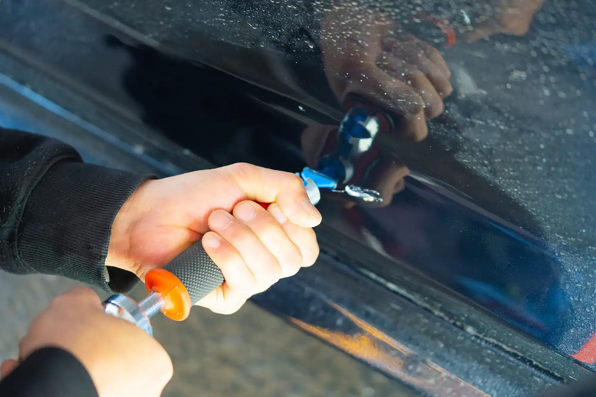 Close-up of a door ding before paintless repair